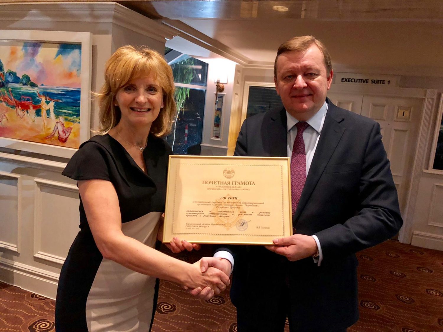 Ambassador Sergei Aleinik bestows Adi Roche with a certficiate of distinction